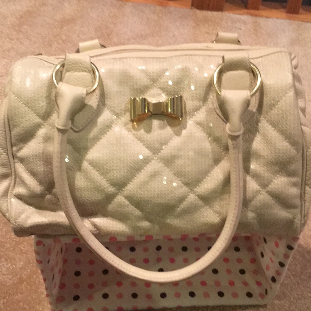 Beige purse with gold bow